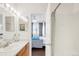 Bathroom view showcasing vanity, mirror, and doorway leading to bedroom at 8944 Fox Dr # 203, Thornton, CO 80260