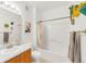 Bathroom with a shower-tub combo, single sink vanity, and decorative plants at 8944 Fox Dr # 203, Thornton, CO 80260
