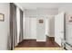 Bedroom with modern style and dark hardwood floors, featuring access to several rooms and closets at 8944 Fox Dr # 203, Thornton, CO 80260