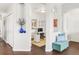 Inviting entryway featuring dark hardwood floors, white walls with arched doorways, and a blue vase with floral arrangement at 8944 Fox Dr # 203, Thornton, CO 80260