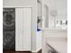 Laundry area featuring stacked washer and dryer next to a pantry/storage area at 8944 Fox Dr # 203, Thornton, CO 80260