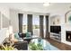 Comfortable living room with large windows, a fireplace, and modern decor at 8944 Fox Dr # 203, Thornton, CO 80260