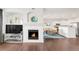 Open-concept living area with fireplace, TV area, dining area and kitchen at 8944 Fox Dr # 203, Thornton, CO 80260