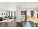 Open-concept living and dining area with dark wood floors, modern decor, and great natural light at 8944 Fox Dr # 203, Thornton, CO 80260