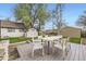 Backyard featuring a wooden deck with an outdoor dining table, and additional storage at 4425 S Lincoln St, Englewood, CO 80113