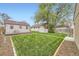 Backyard showcasing a lush lawn, patio area, storage shed, and mature trees for outdoor enjoyment at 4425 S Lincoln St, Englewood, CO 80113