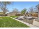 Backyard features a spacious lawn, wooden deck, and storage shed in this serene outdoor space at 4425 S Lincoln St, Englewood, CO 80113