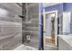 Updated bathroom with gray tile shower and blue walls at 4425 S Lincoln St, Englewood, CO 80113