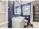 Bathroom with custom vanity, blue accent wall, shower and window at 4425 S Lincoln St, Englewood, CO 80113