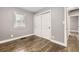 Bedroom featuring hardwood floors, neutral paint, window and large closet at 4425 S Lincoln St, Englewood, CO 80113