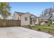 Cozy home featuring a large concrete driveway and well-maintained landscaping at 4425 S Lincoln St, Englewood, CO 80113
