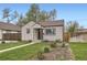 Quaint single-Gathering home with a green lawn and garden beds, showcasing curb appeal at 4425 S Lincoln St, Englewood, CO 80113
