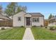 Charming single-story home with a well-manicured lawn and walkway leading to the front door at 4425 S Lincoln St, Englewood, CO 80113