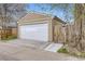 Exterior garage view showcasing a well-maintained door, adjacent fence, and concrete driveway at 4425 S Lincoln St, Englewood, CO 80113