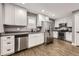 Modern kitchen with white cabinetry, stainless steel appliances, and quartz countertops at 4425 S Lincoln St, Englewood, CO 80113