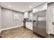 Bright kitchen with white cabinets, stainless steel refrigerator, and hardwood floors at 4425 S Lincoln St, Englewood, CO 80113