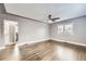 Bright and airy living room with hardwood floors, neutral paint, and modern ceiling fan at 4425 S Lincoln St, Englewood, CO 80113