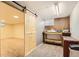 Basement area with sliding barn door leading to workshop space at 3480 S Dayton St, Denver, CO 80231