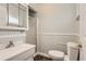 A full bathroom featuring a shower with glass door, vanity sink, and toilet at 3480 S Dayton St, Denver, CO 80231