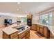 Open concept kitchen with custom island, modern appliances, and seamless flow to living area at 3480 S Dayton St, Denver, CO 80231