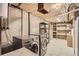 Functional laundry room featuring modern washer and dryer with extra storage at 3480 S Dayton St, Denver, CO 80231