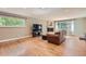 Inviting living room with hardwood floors, a fireplace, and large windows for ample natural light at 3480 S Dayton St, Denver, CO 80231