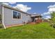Well-maintained back yard features green lawn, wood fence, and covered deck at 11030 Glacier Park Cir, Parker, CO 80138