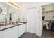 Bathroom with double vanity, large mirror and a doorway to a walk-in closet at 11030 Glacier Park Cir, Parker, CO 80138