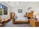 Bright bedroom featuring a comfortable bed, wooden furnishings, and a sunny window at 11030 Glacier Park Cir, Parker, CO 80138