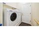 Well-equipped laundry room with modern washer and dryer units, with storage and a door to outside at 11030 Glacier Park Cir, Parker, CO 80138