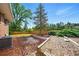 Landscaped backyard featuring bark mulch, stone features, and lush greenery, ideal for outdoor enjoyment at 1818 South Union Ct, Lakewood, CO 80228