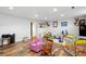Spacious finished basement with wood flooring and ample space for recreation and play at 1818 South Union Ct, Lakewood, CO 80228