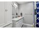 Bright bathroom featuring a double sink vanity with a marble countertop and stylish fixtures at 1818 South Union Ct, Lakewood, CO 80228