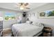 Bright bedroom with a ceiling fan, two windows and wood-look flooring at 1818 South Union Ct, Lakewood, CO 80228