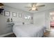 Comfortable bedroom with ceiling fan, wood-look flooring, and bright natural light at 1818 South Union Ct, Lakewood, CO 80228
