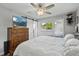 Bedroom featuring a ceiling fan, mirror, dresser with TV and wood-look flooring at 1818 South Union Ct, Lakewood, CO 80228