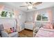 Charming bedroom with two windows, a chair, and a bed at 1818 South Union Ct, Lakewood, CO 80228