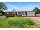 Charming ranch-style home with brick accents, well-manicured lawn, and attached two-car garage at 1818 South Union Ct, Lakewood, CO 80228