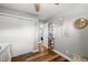 Hallway featuring wood-look flooring, closet, and decorative elements at 1818 South Union Ct, Lakewood, CO 80228