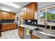 Well-lit kitchen with stainless steel sink, granite countertops and tile backsplash at 1818 South Union Ct, Lakewood, CO 80228