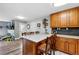 Spacious kitchen island with breakfast bar offers seamless flow to an adjacent Gathering room at 1818 South Union Ct, Lakewood, CO 80228