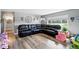 Bright living room with stylish hardwood floors and an ample, leather sectional sofa for Gathering and guests at 1818 South Union Ct, Lakewood, CO 80228