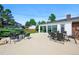 Spacious back patio featuring multiple seating areas and a view of the sunroom and backyard at 1818 South Union Ct, Lakewood, CO 80228