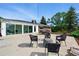 Back patio with ample seating and a glimpse of the home's sunroom, perfect for outdoor gatherings at 1818 South Union Ct, Lakewood, CO 80228