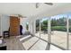 Bright sunroom featuring sliding glass doors, wood flooring, and a charming brick wall at 1818 South Union Ct, Lakewood, CO 80228