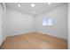 Bright, minimalist bedroom with hardwood floors, a window, and neutral walls at 974 N Faver Dr, Castle Rock, CO 80109