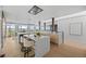 Open-concept kitchen with a large island, bar seating, and modern lighting fixtures at 974 N Faver Dr, Castle Rock, CO 80109