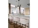 Sleek kitchen bar featuring quartz counters, pendant lighting, and modern barstools at 974 N Faver Dr, Castle Rock, CO 80109