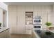 Chef's kitchen with light wood cabinets, built-in appliances, and a stylish, functional design at 974 N Faver Dr, Castle Rock, CO 80109