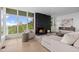 Bright living room with a modern fireplace, expansive windows, and beautiful views of the scenery at 974 N Faver Dr, Castle Rock, CO 80109